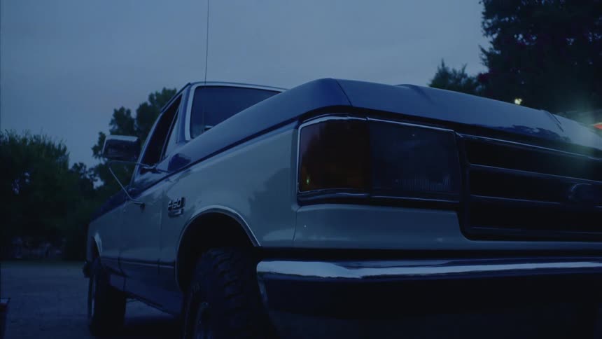 Vintage car turning off its front headlight