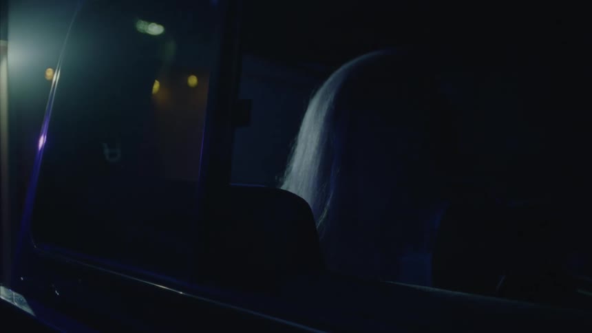 A clip of a blond female in a car
