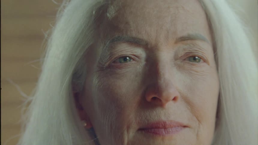 A woman opens her eyes and smiles