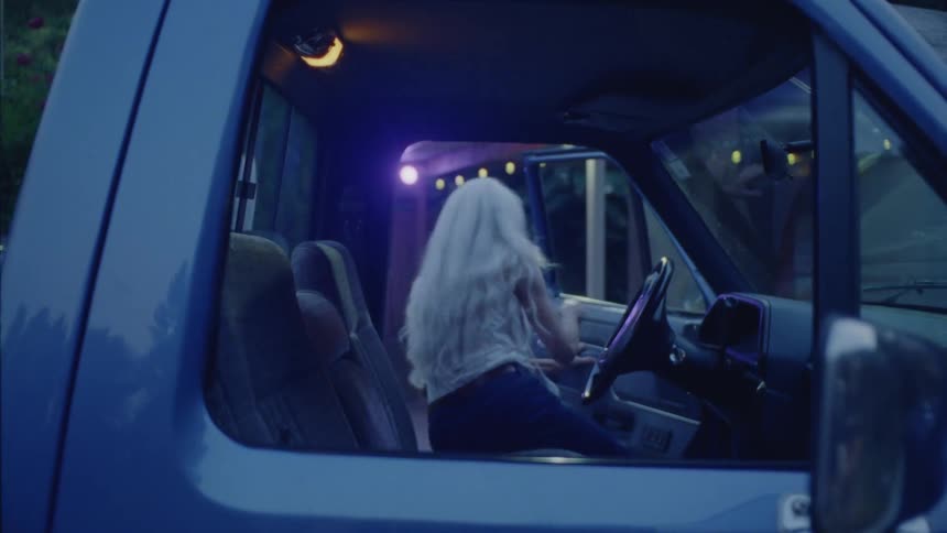 A woman turns off the truck and gets out
