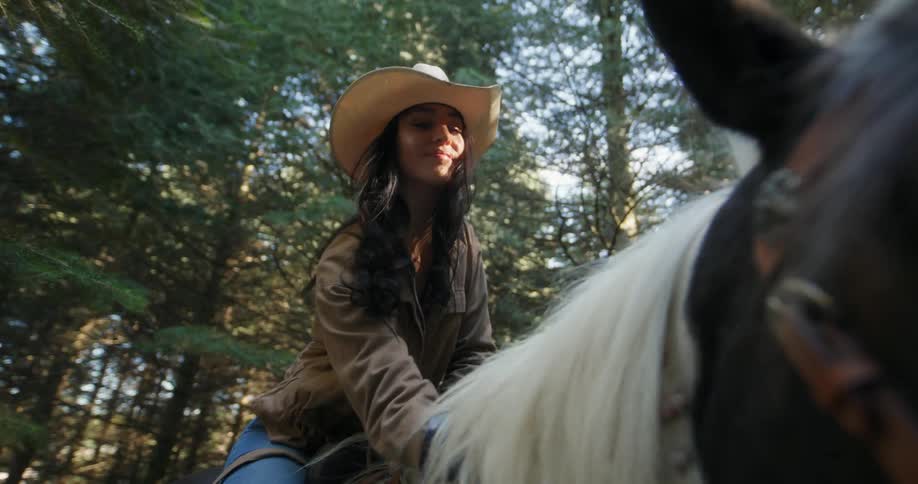 A woman riding a horse in the forest
