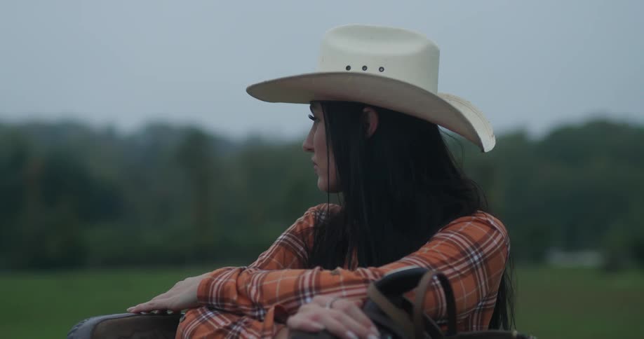 A woman in a cowboy hat on a ranch