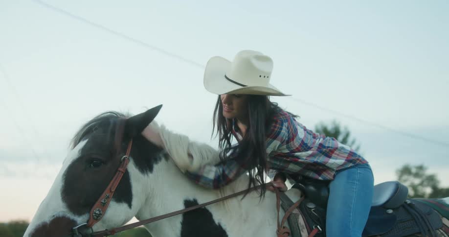 A woman is petting her horse