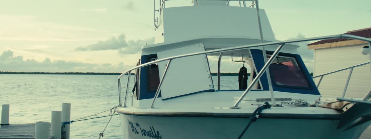 View of a yacht docked at a marina in the morning