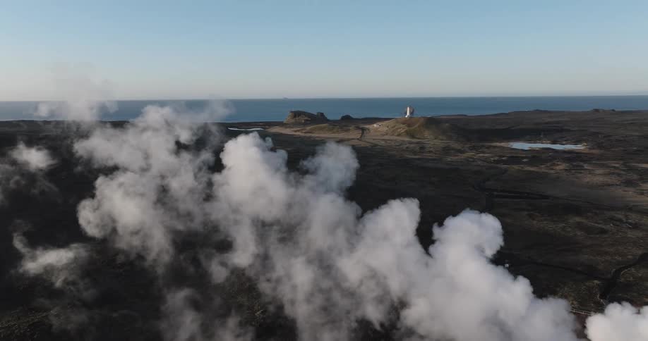 An aerial view of steam rising on a coastal plateau in the morning