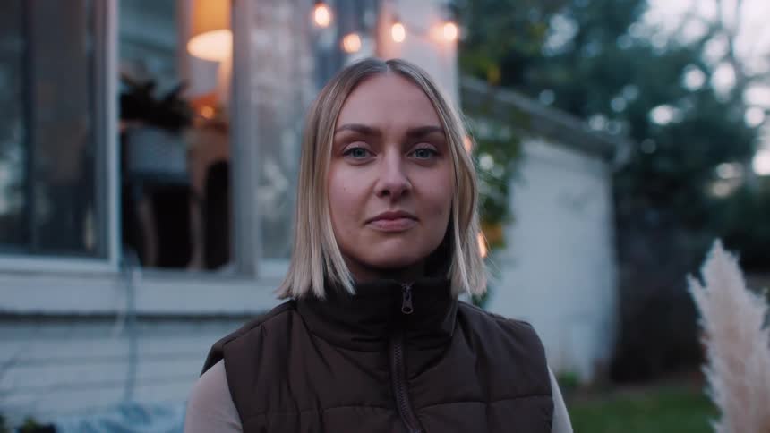 Portrait of a young blonde woman in the backyard