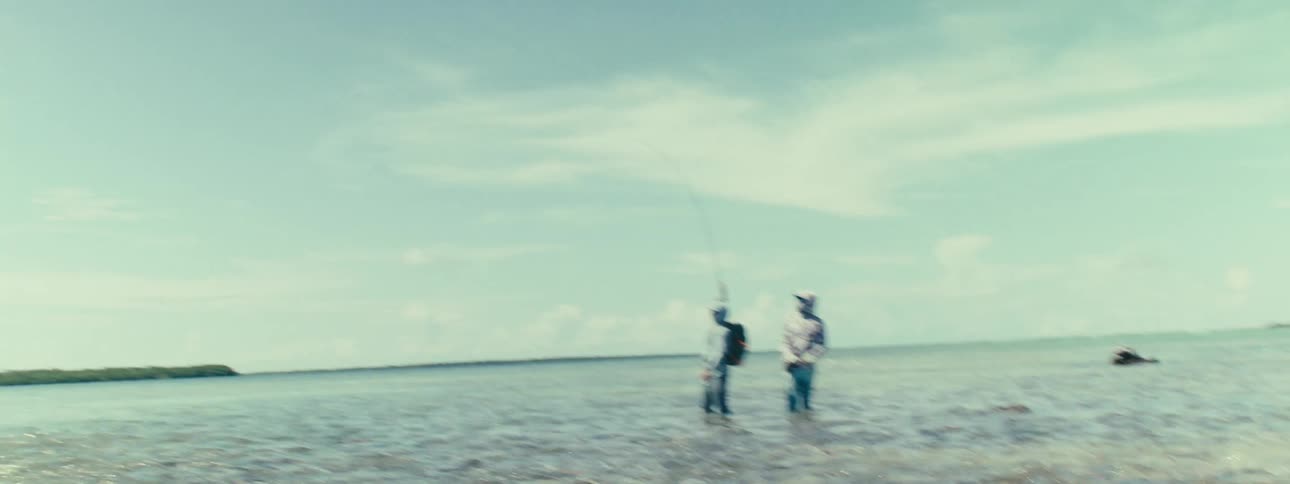 Men fishing in a sea with crystal clear waters during the day