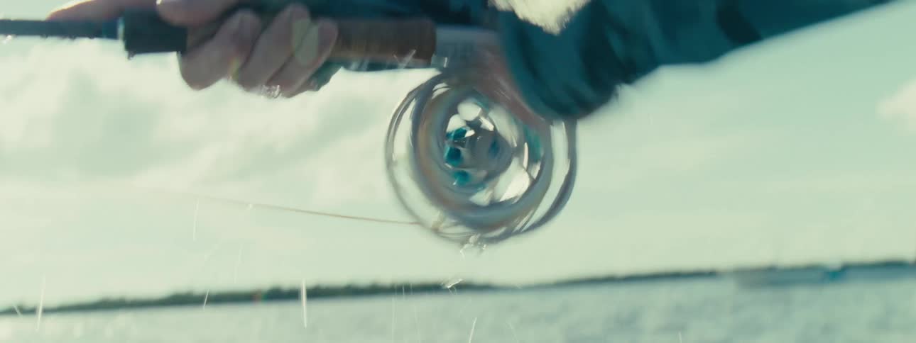A person fishing in the deep sea during the day