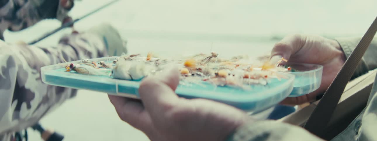 People make fishing lures outdoors