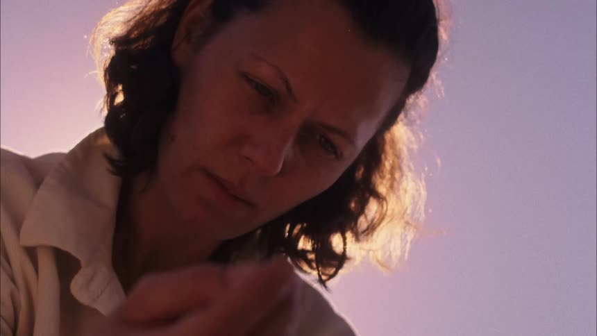 A woman is showing attention to something in her hand
