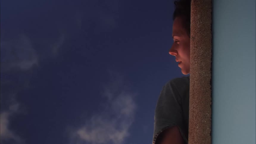 A woman lying down looking at the sky