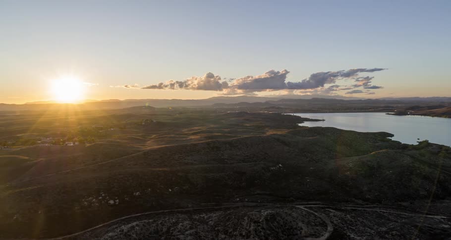 An aerial view of a region with a lake and a falcon