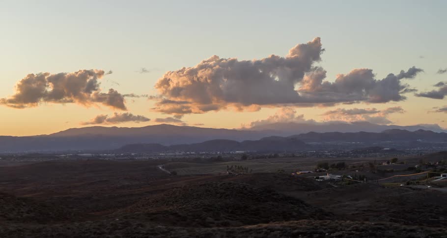 Aerial panorama of a landscape with pasture and a highway under a morning sky