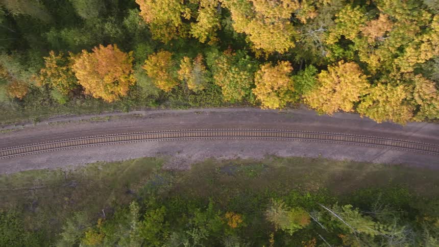 An aerial view of a rail path in the woods