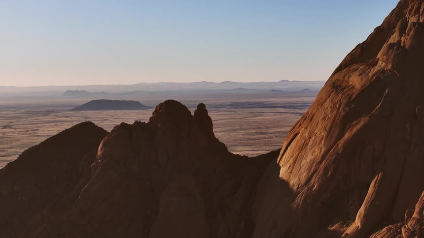Sun shines on the solpes of a mountain in the desert