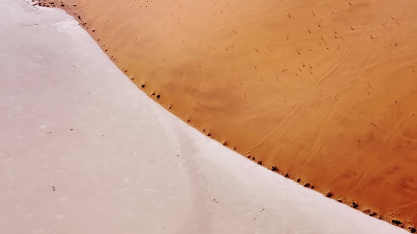 Aerial of split desert with white and yellow sand