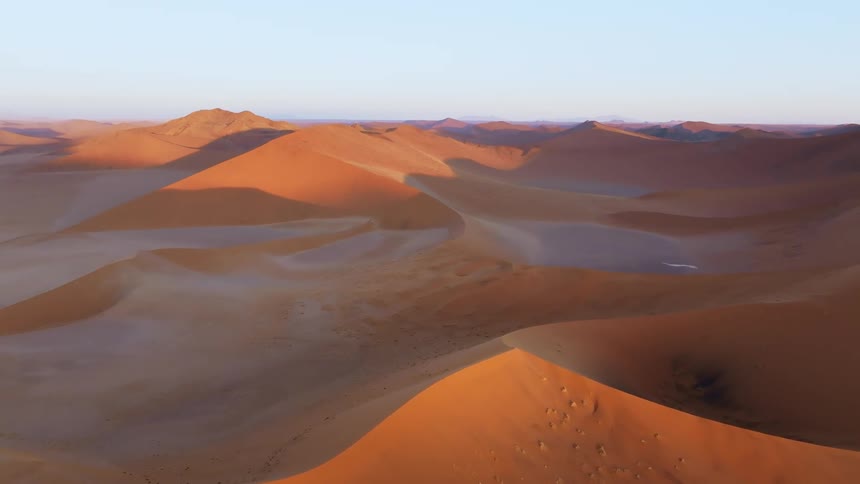 Aerial panorama of desert dunes in a morning sky