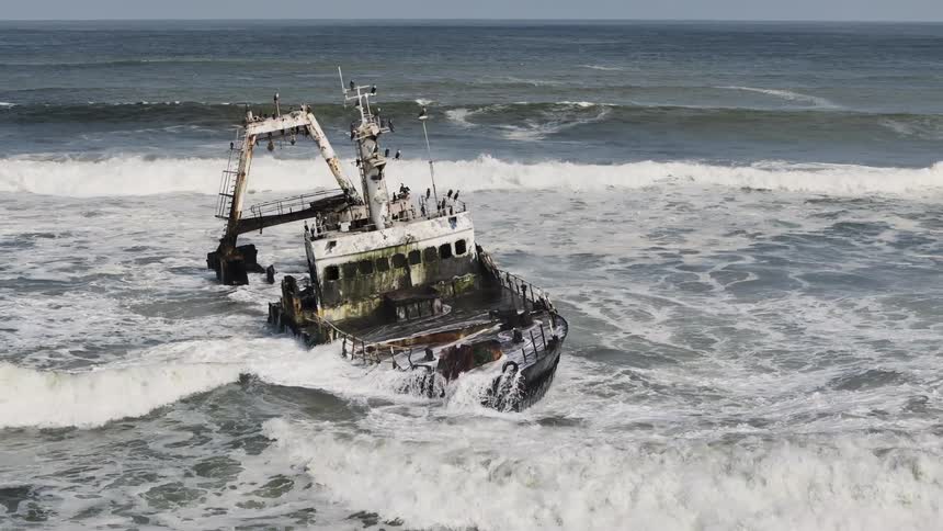 Aerial of a warship stranded on a desert island