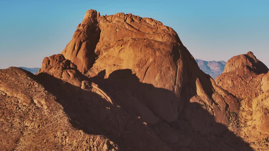 Aerial of a mountain peak during a sunny morning