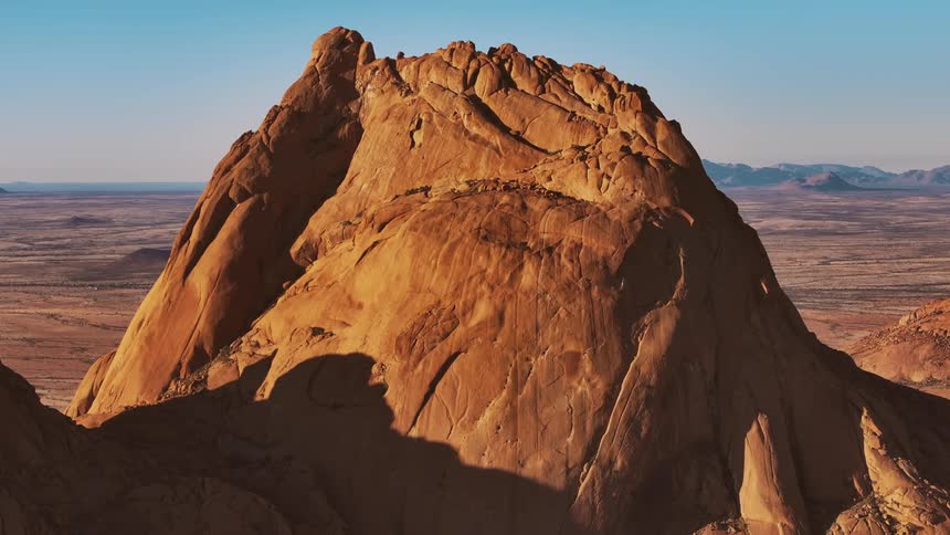Aerial of red mountain in the desert during daytime