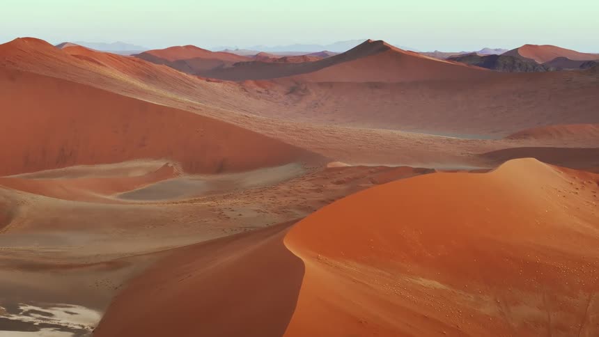 Aerial of dunes in the desert during sunrise