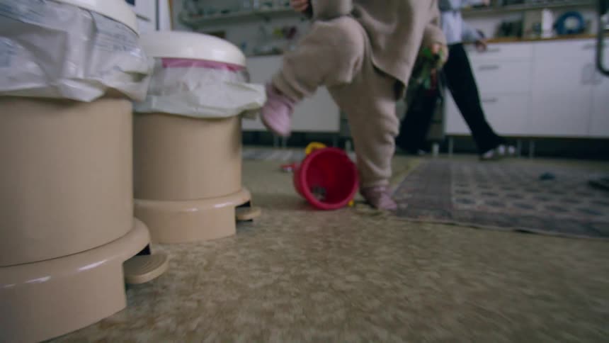 A baby running on a wooden floor