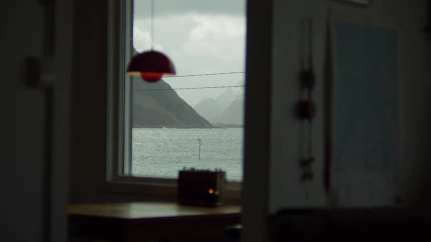 The ocean and mountains seen from the window of a building