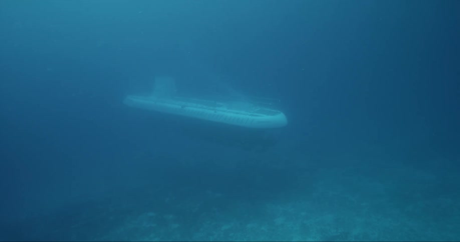 Underwater shot of a submarine near the bottom of the ocean