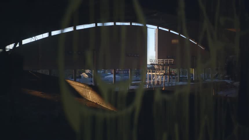Reflection of a diving board in a large swimming pool