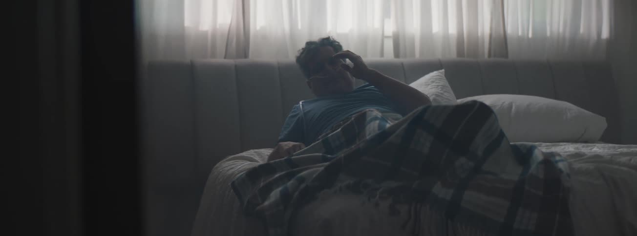 Senior man waking up from a nap in his room