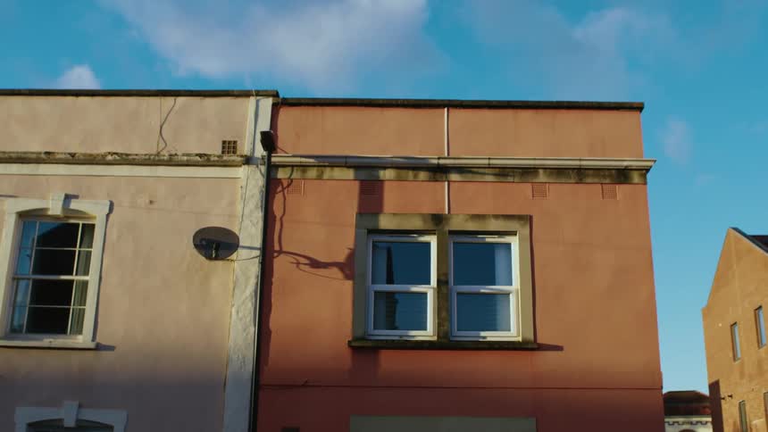 The apartment buildings have may windows