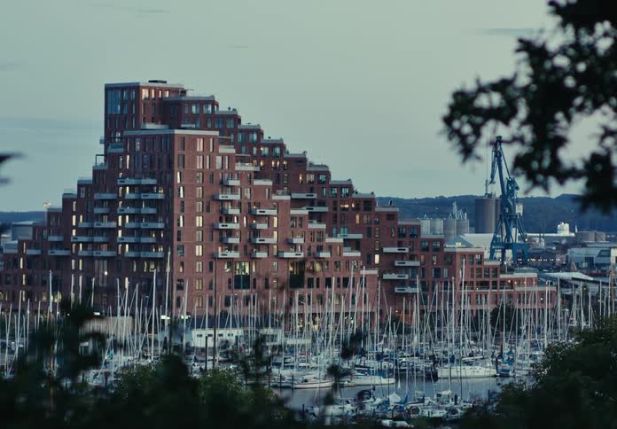 A large apartment building is near the harbor
