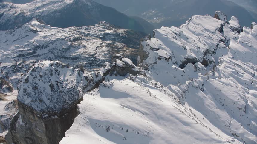 Aerial of a mountain peak covered in ice and snow
