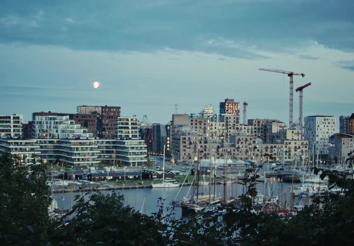Boats buildings at waterfront in a metropolitan area at sunset