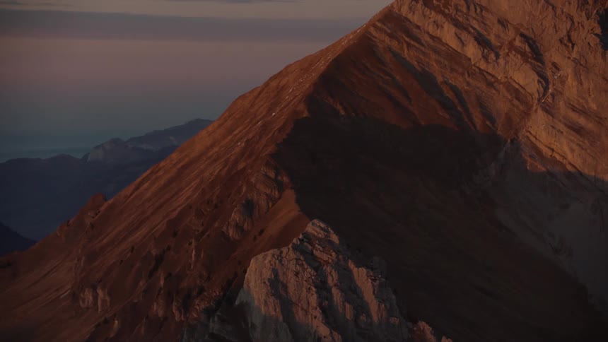 Aerial of a rocky mountain peak during sunrise