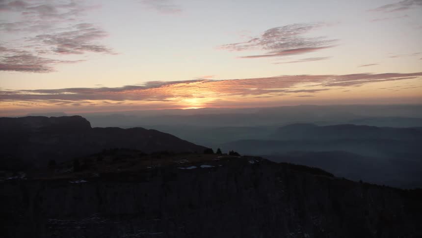 Aerial panorama of peaks and mountains under a dawn sky