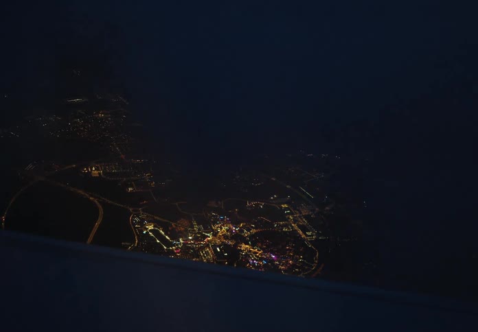 Skyline of a city illuminated at night seen from the plane