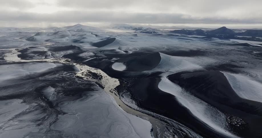 Aerial of frozen mountains and rivers in winter