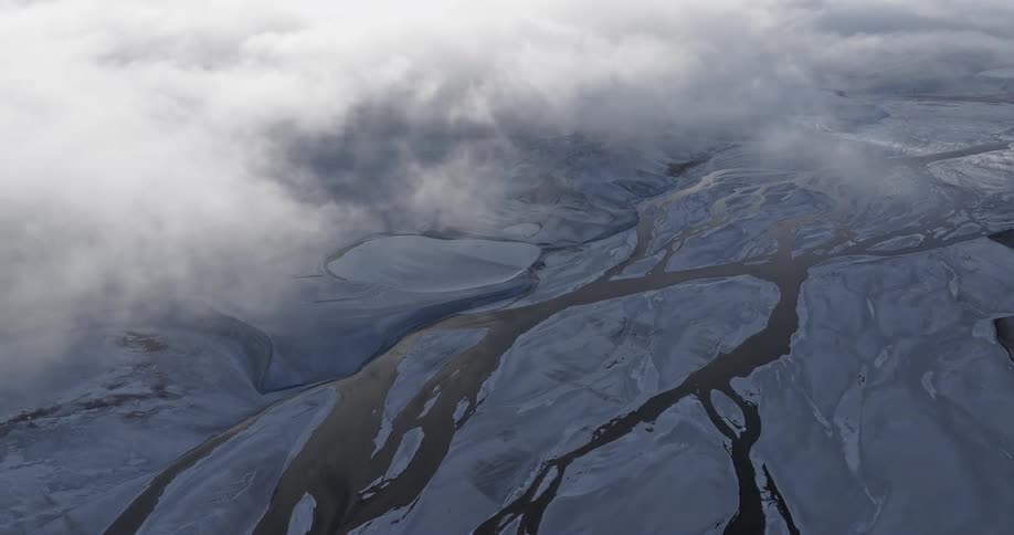 Aerial of river and frozen plains in winter