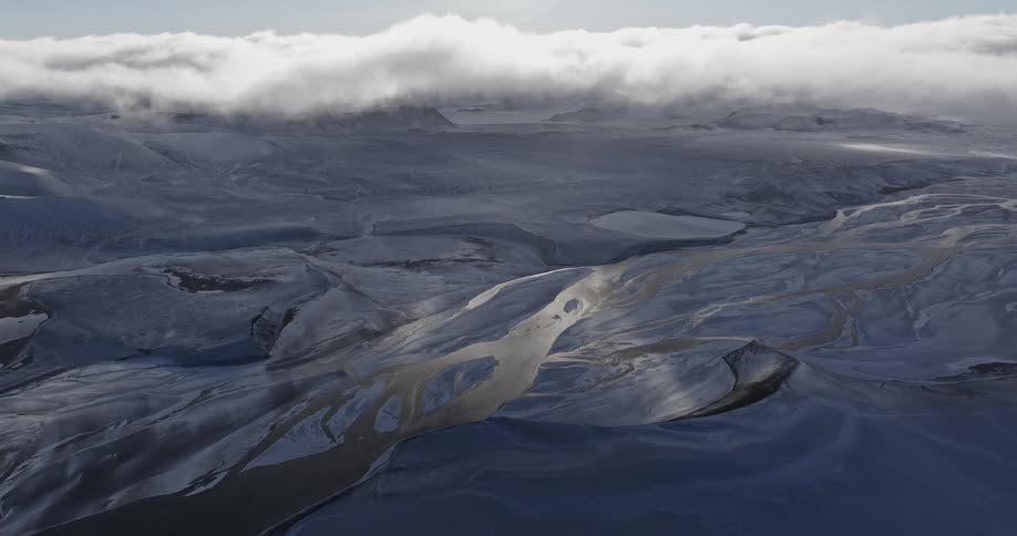 The landscape is frozen with heavy clouds above