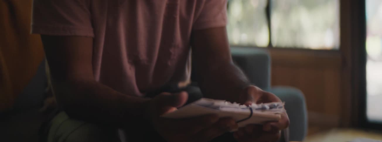 Man looks through old letters and handles other items in a memory box