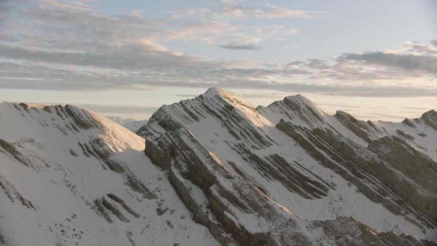 Aerial of mountain peak with ice at dawn