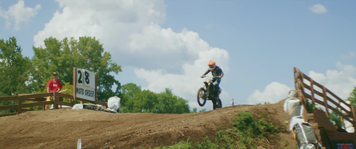 A person in a motocross competition on a dirt track