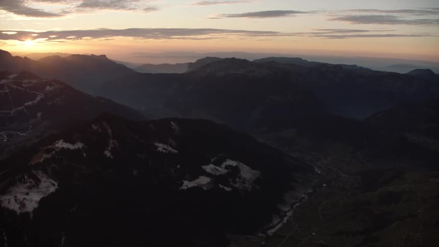 Aerial of the valley surrounded by mountains at dawn