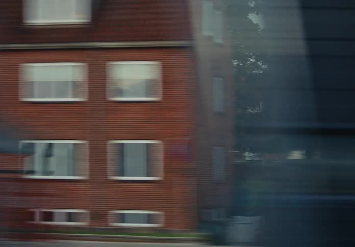 View of residential windows passing by on a cloudy day
