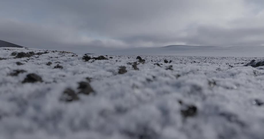 Snowcovered plain with mountains in the background
