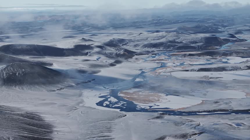 An arctic region with snow mountains and the entire ground covered in snow