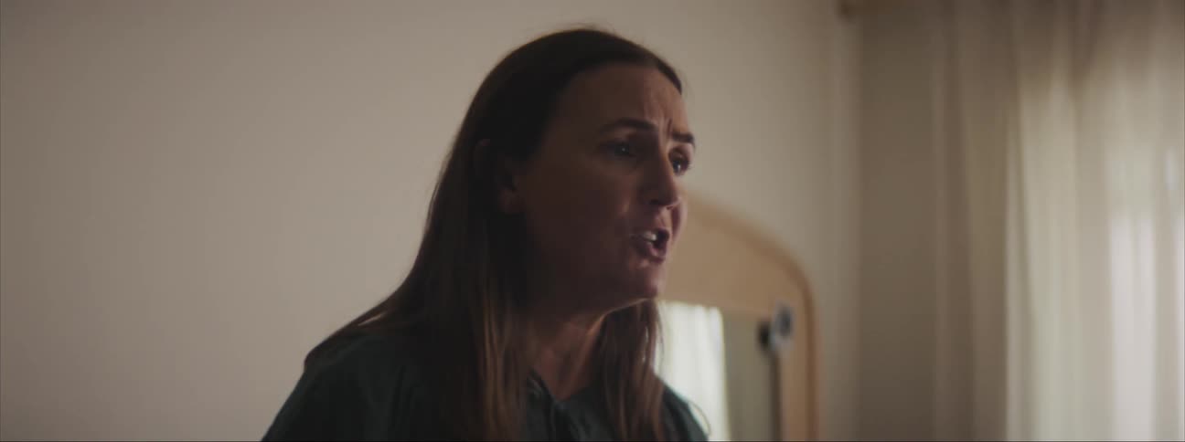Middle aged woman at home arguing with someone and yelling