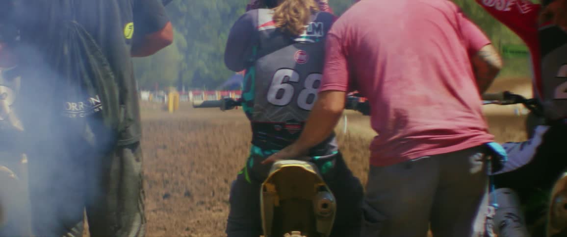 Motocross athletes on a track with their instructors motivating them