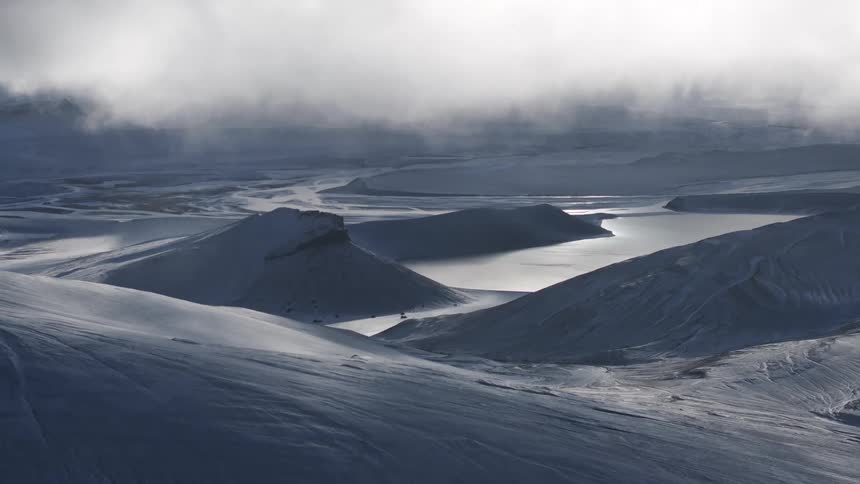 Aerial view of low clouds over a barren tundra